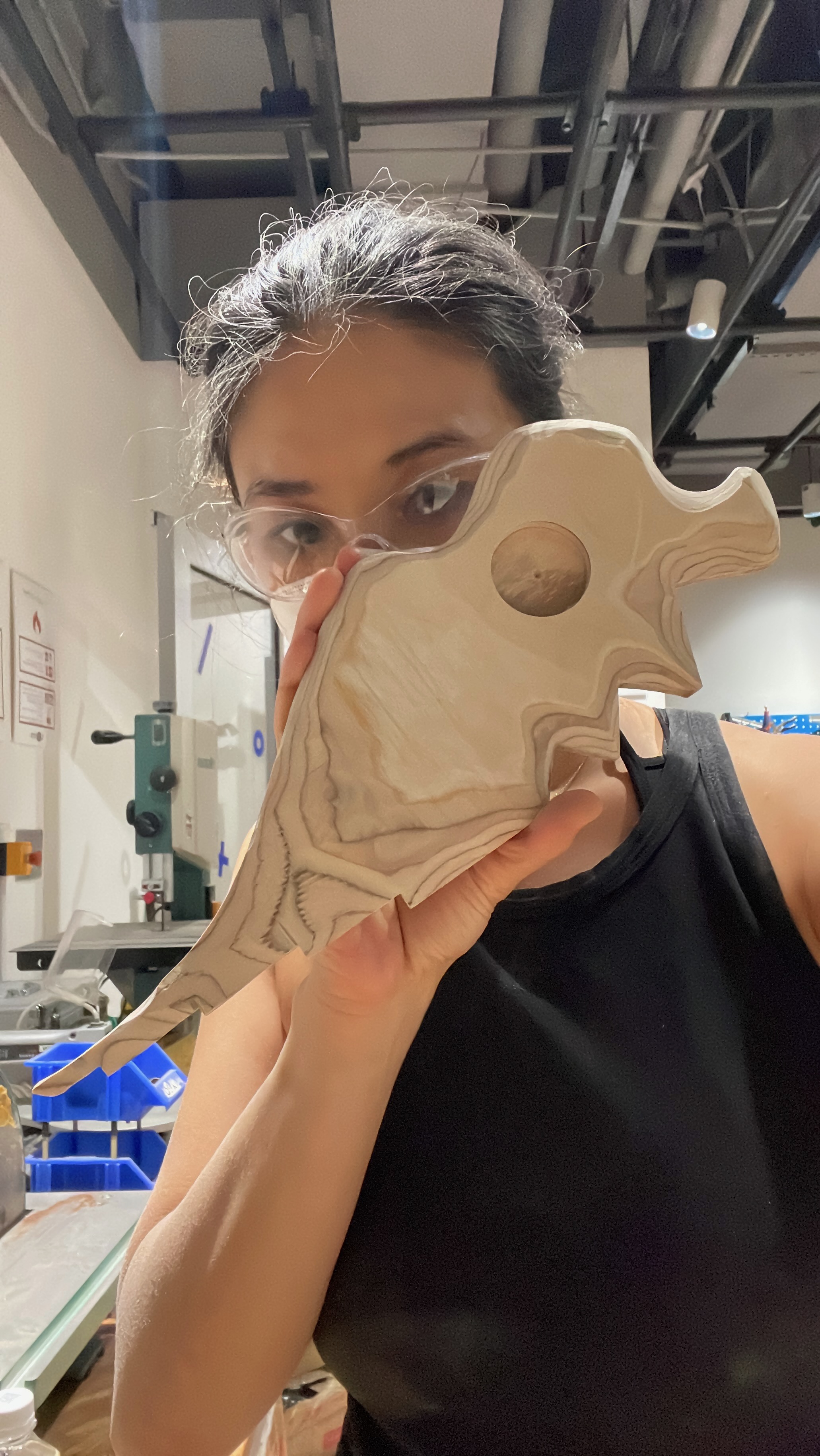 Woodworking — holding a bandsaw-cut layered wood piece in the shop